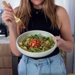 A vibrant and healthy bowl of edamame soba noodles topped with a flavorful sauce.
