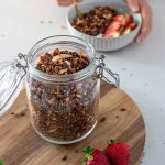 A mouthwatering jar of chocolate granola, perfectly baked and ready to be enjoyed.