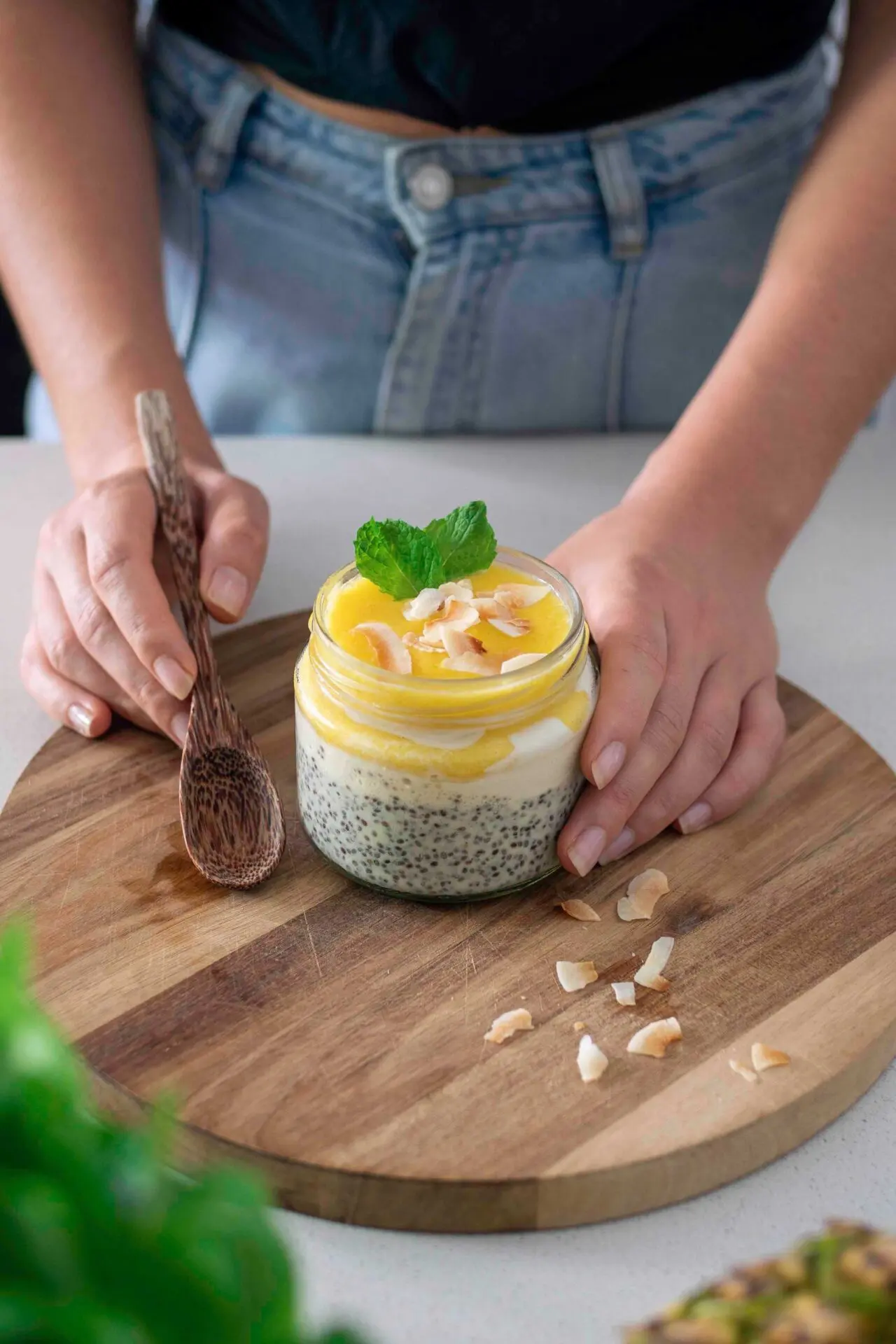 Pina colada chia pudding topped with fresh pineapple and coconut flakes