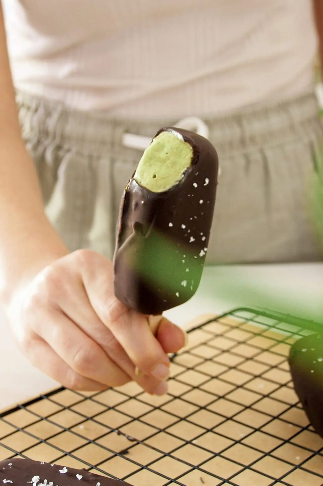 Avocado mint chocolate ice cream with bit taken from it