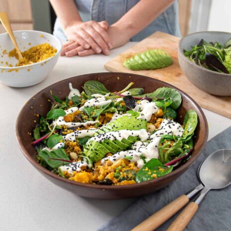 Wooden salad bowl with Roasted Pumpkin, Turmeric Quinoa & Avocado Salad with Tahini Dressing