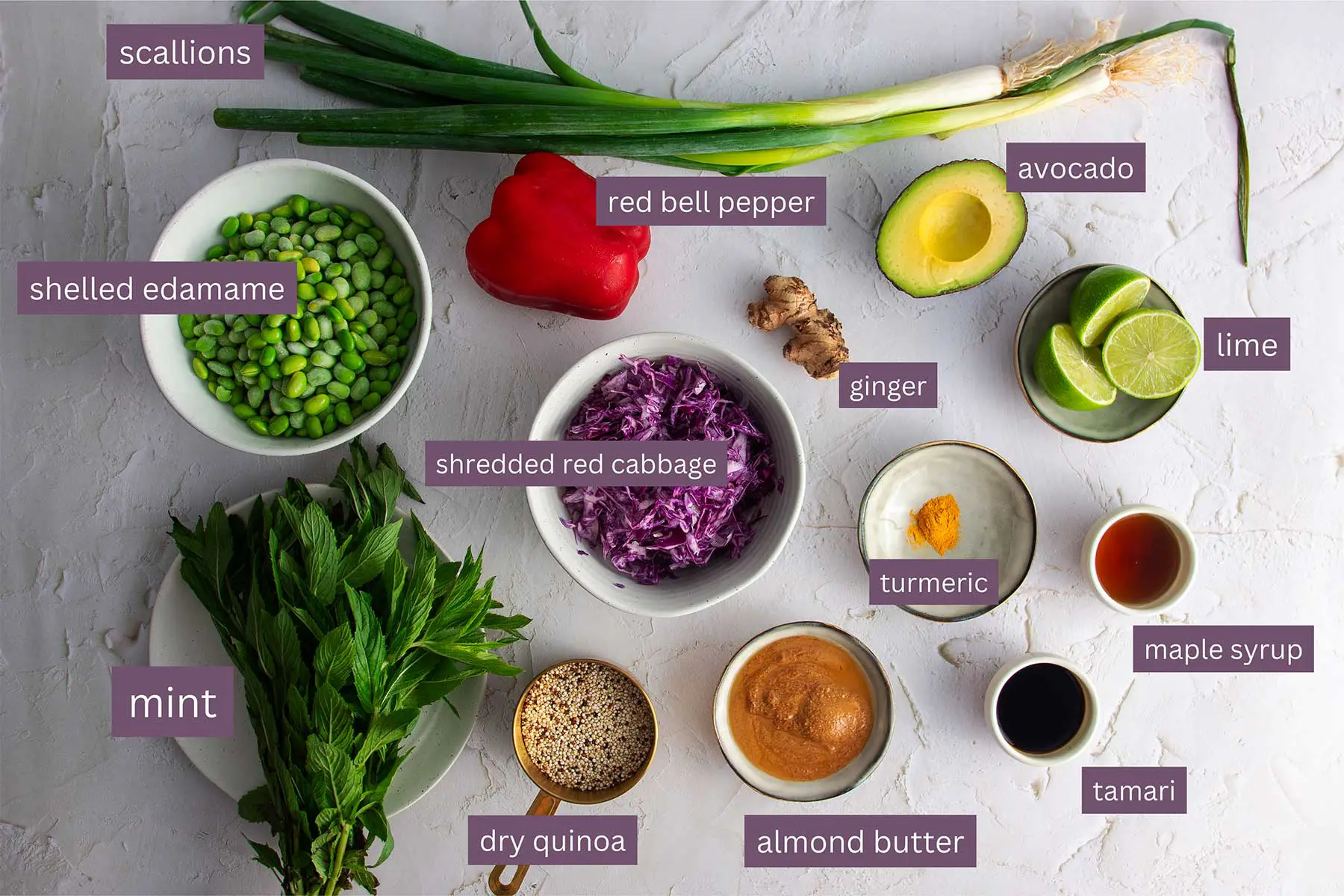 An array of fresh ingredients for Turmeric Quinoa and Edamame Salad Meal Prep neatly laid out on a light surface, labeled for easy identification.