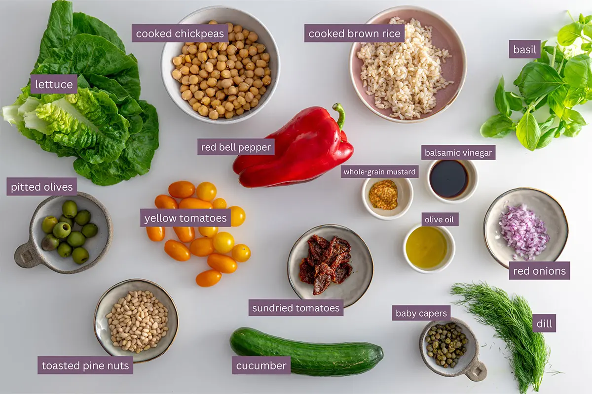 Assorted fresh ingredients for Mediterranean chopped salad labeled for identification.
