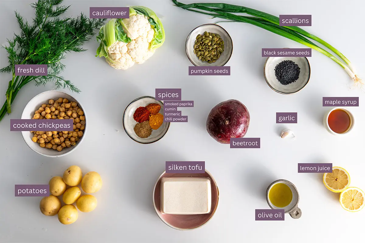 Assorted vibrant ingredients for a high-protein beetroot bowl on a white background.