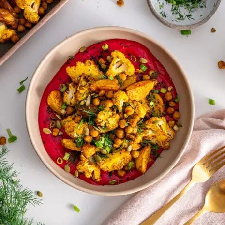 High-protein beetroot bowl with potatoes, chickpeas, and cauliflower, viewed from above.