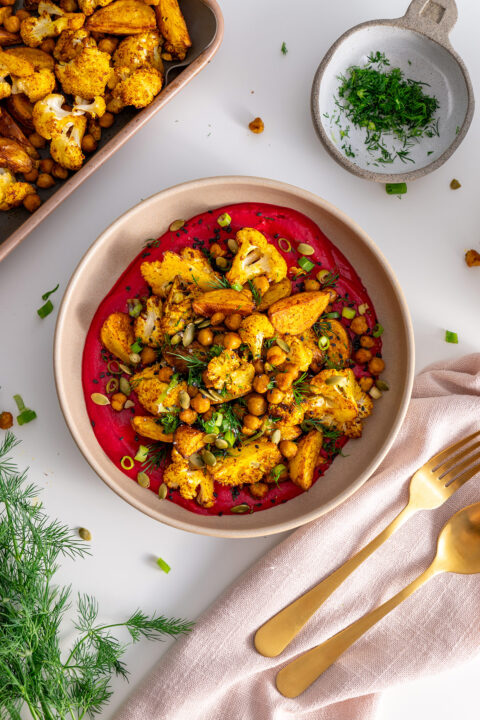 High-protein beetroot bowl with potatoes, chickpeas, and cauliflower, viewed from above.