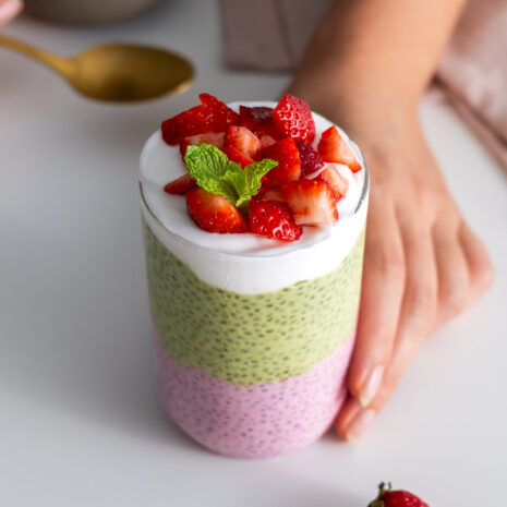 Top-down view of strawberry matcha chia pudding garnished with fresh strawberries.