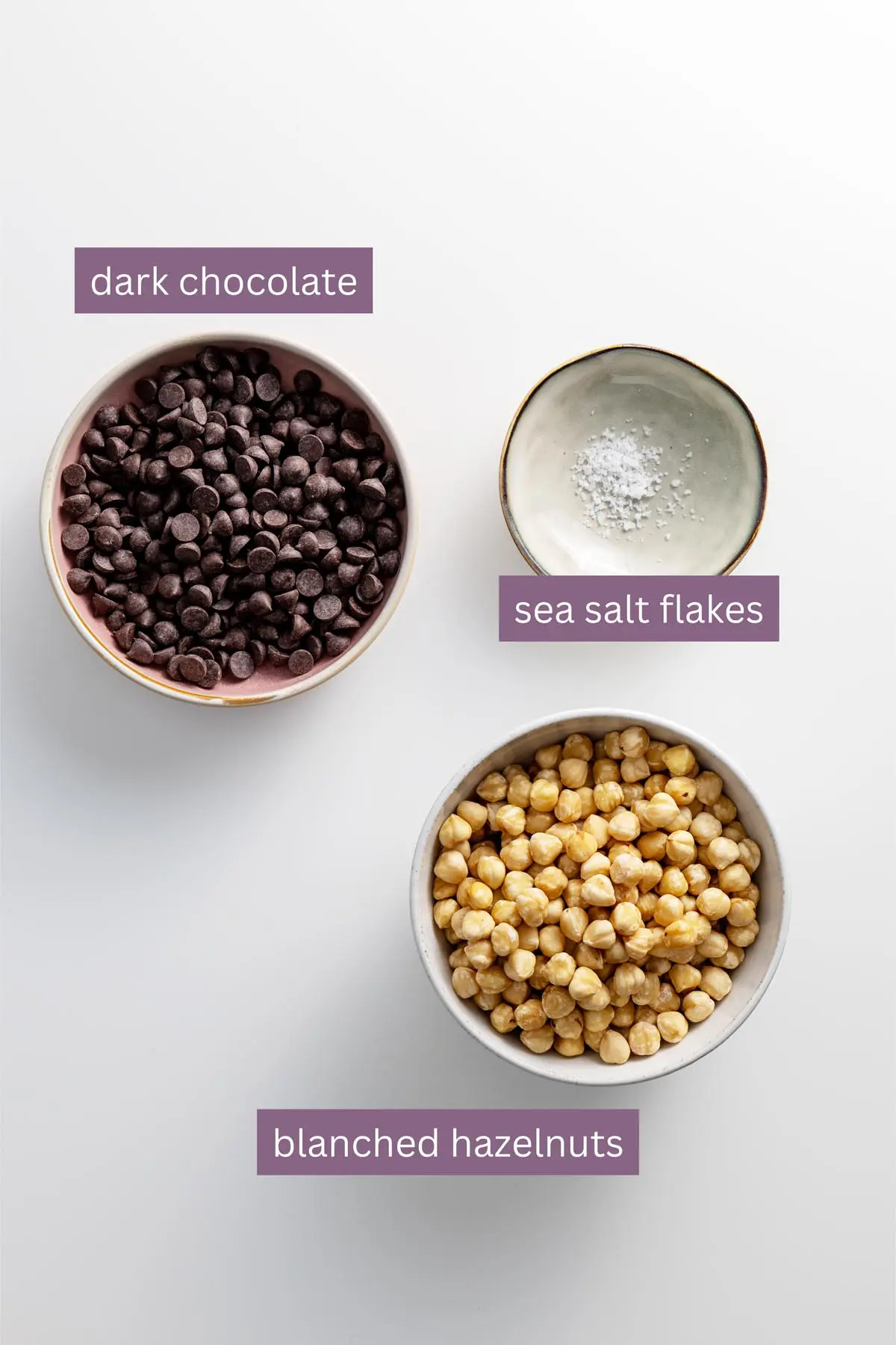 Ingredients for vegan chocolate Nutella spread arranged on a white surface.