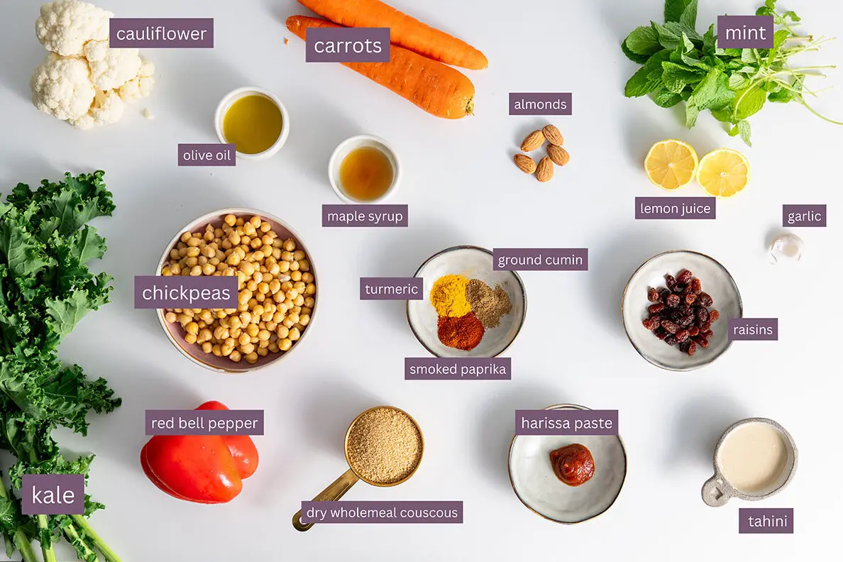 Vibrant ingredients for a Moroccan-inspired nourish bowl on a white surface.