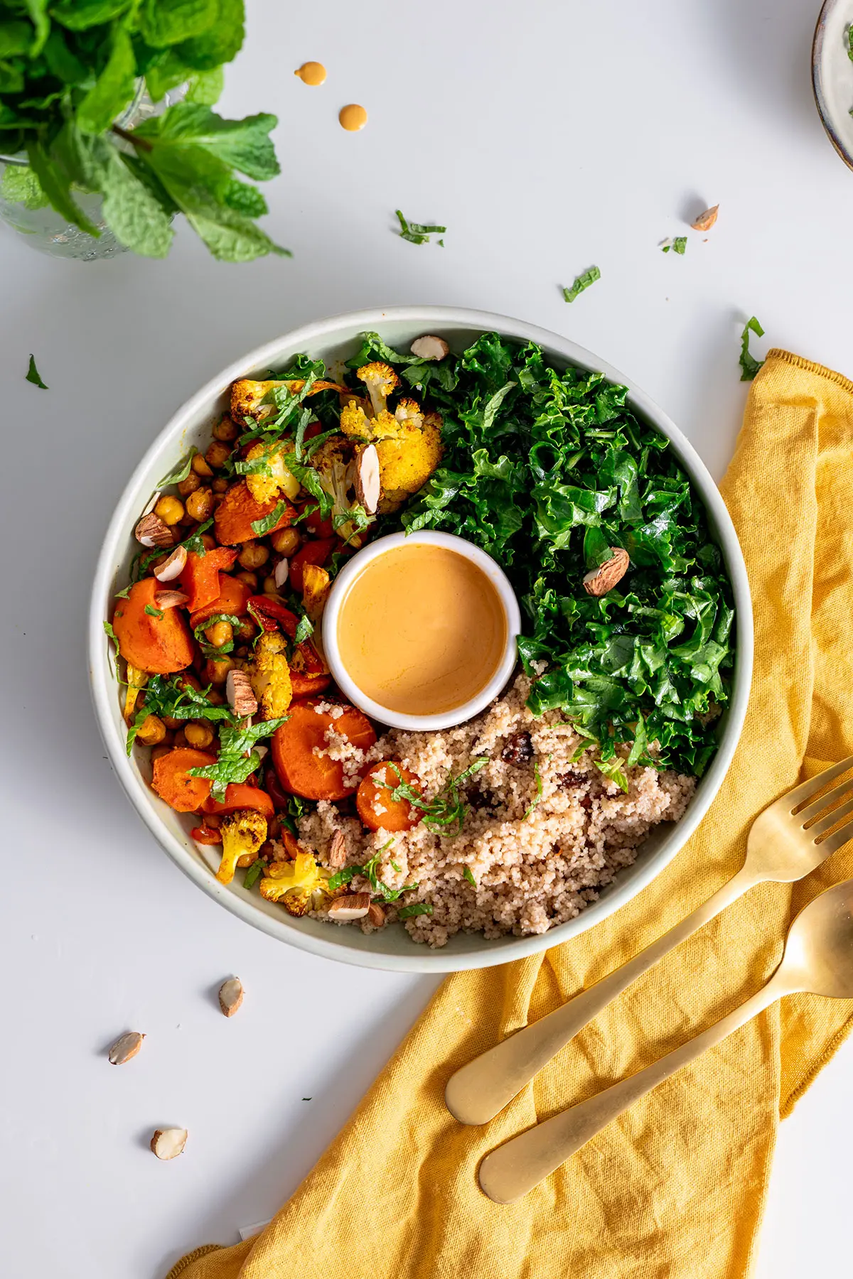 Moroccan-inspired nourish bowl served in a ceramic bowl on a white table.