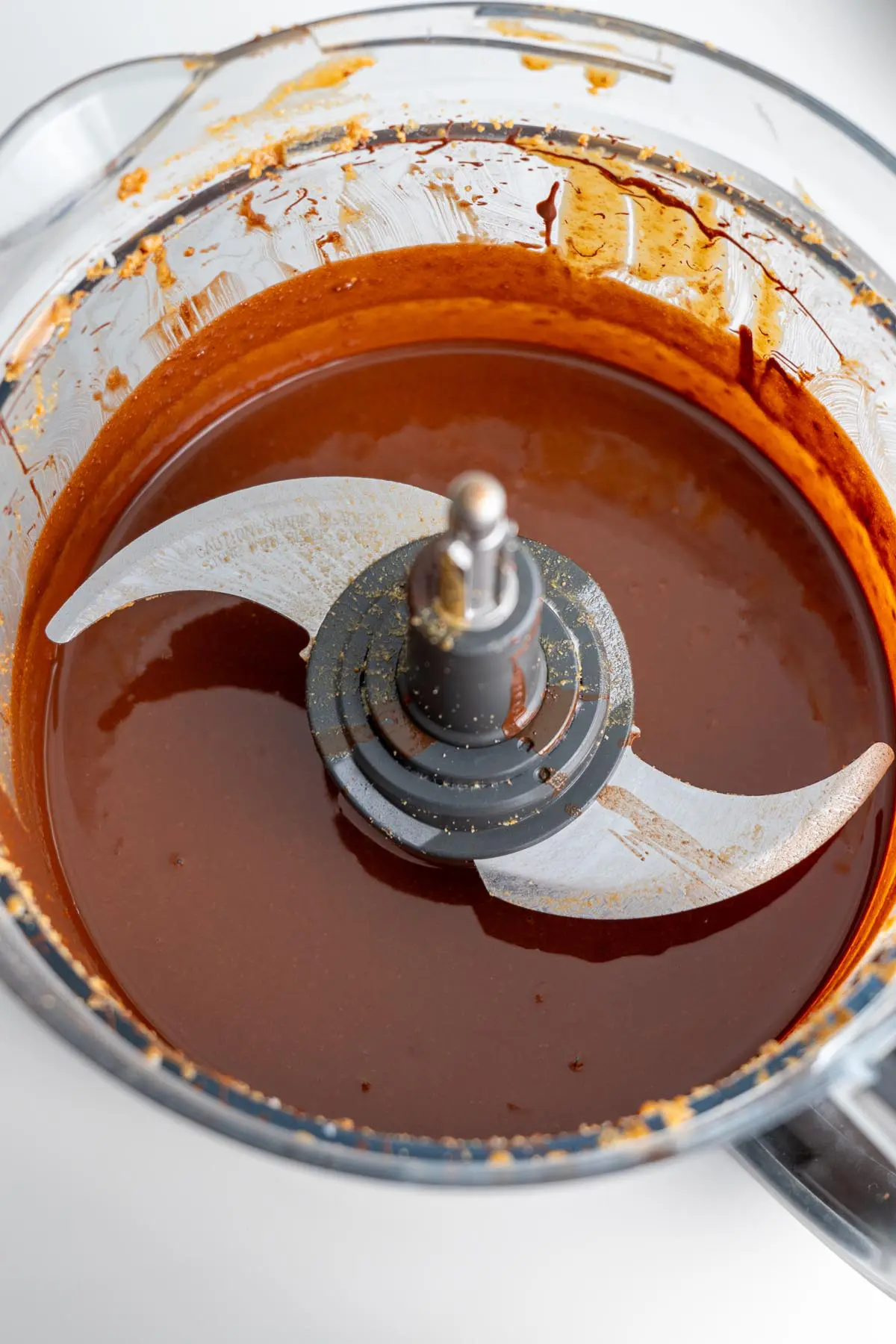 Food processor filled with freshly made vegan chocolate spread.