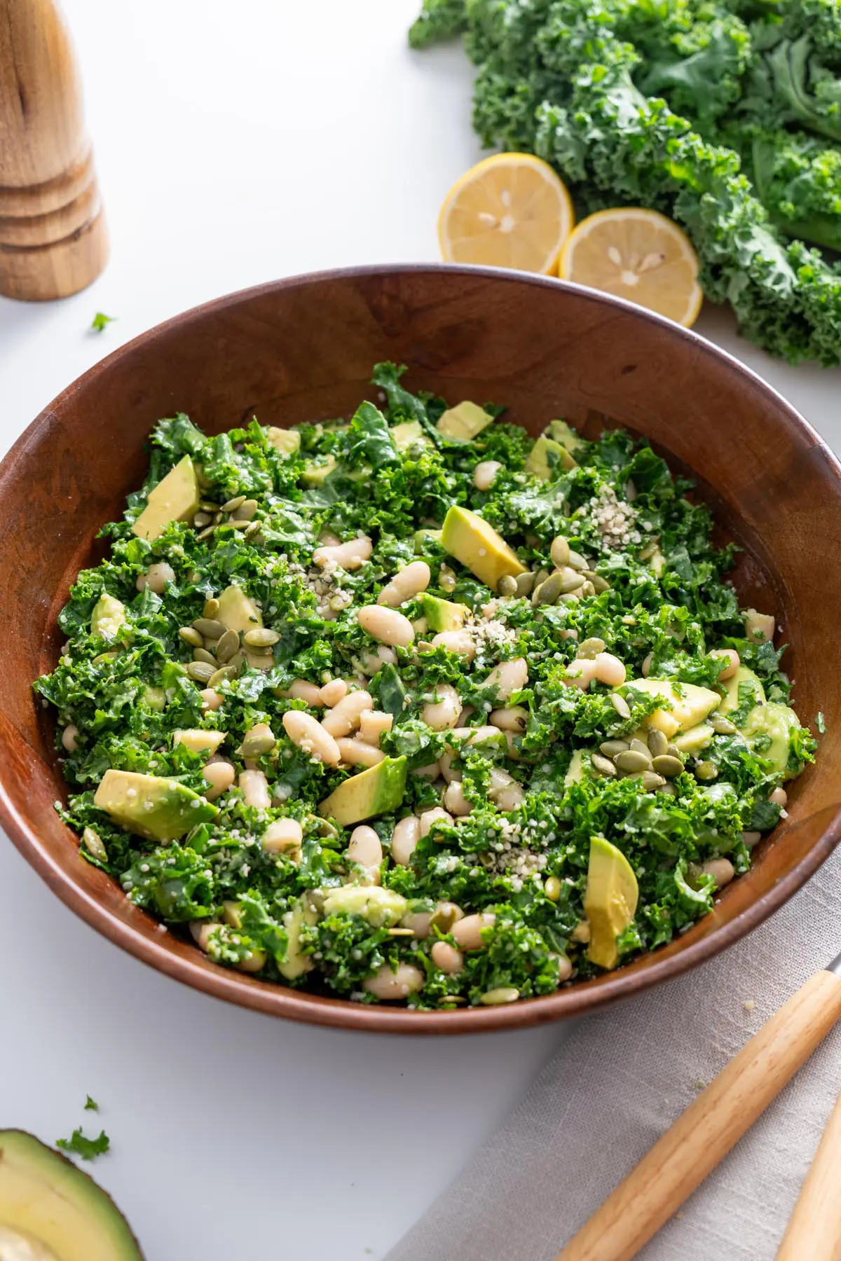 Erewhon kale salad in a wooden bowl, close-up view.