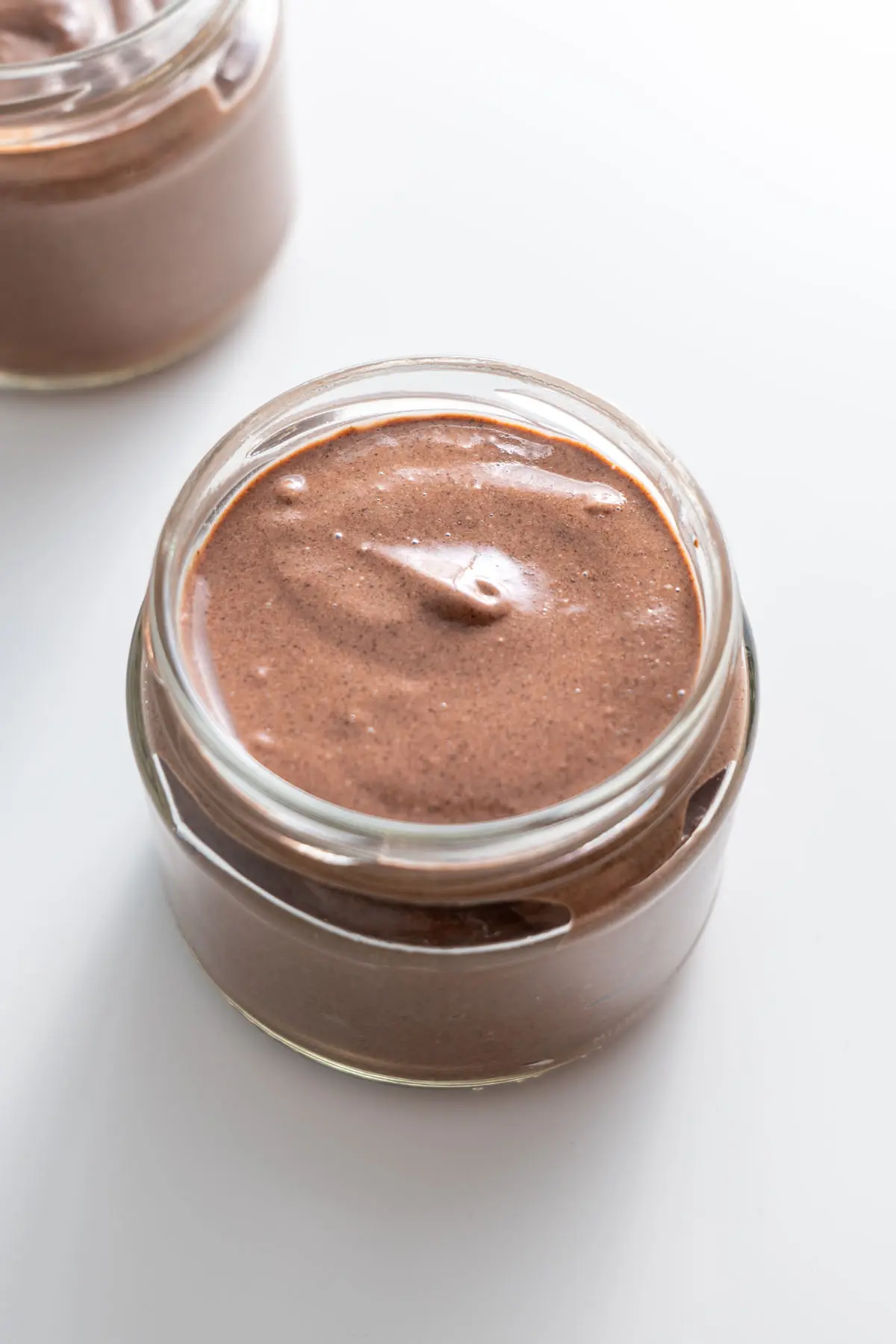 Smooth cacao chia pudding in a jar without toppings.