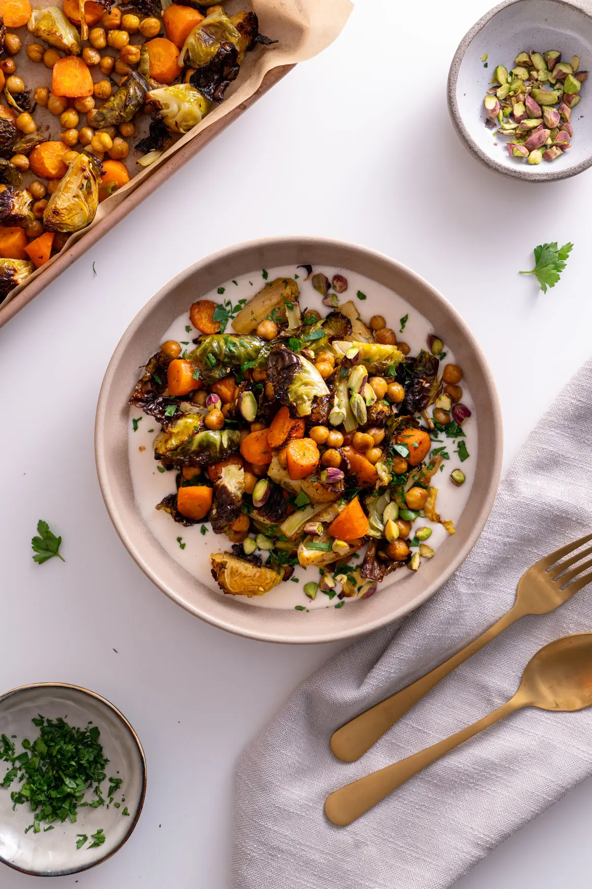 Top view of Sweet & Spicy Roasted Veggies served with fresh garnishes on a White Bean Spread.