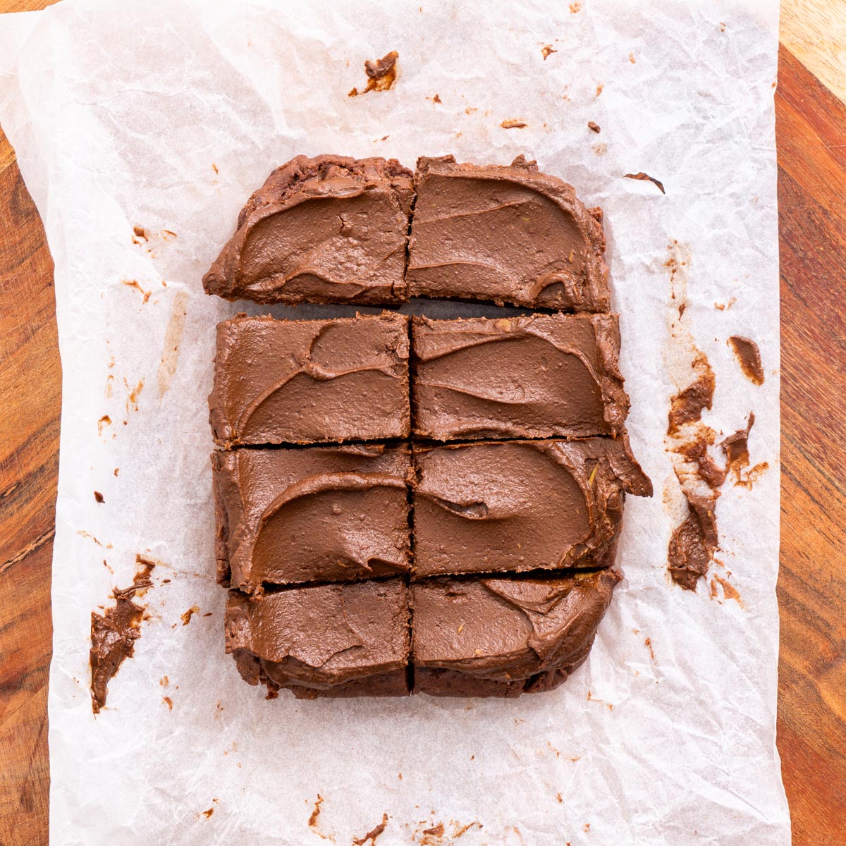 Batch of fudgy no-bake brownies cut into squares on parchment paper