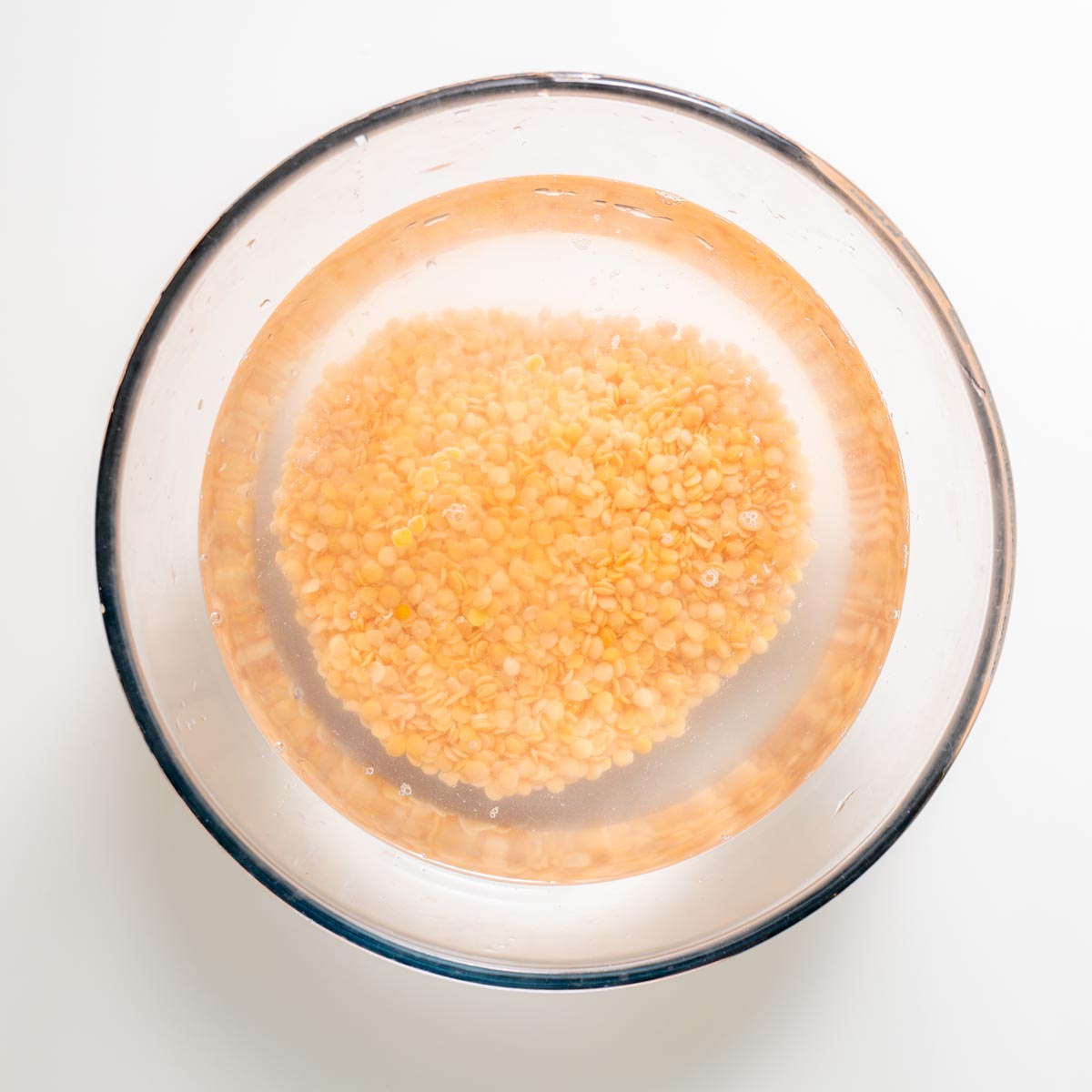 Bowl of red lentils soaking in water