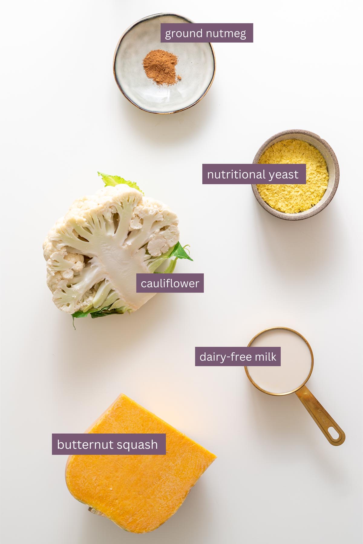 nutmeg nutritional yeast cauliflower dairy free milk and butternut squash on white surface