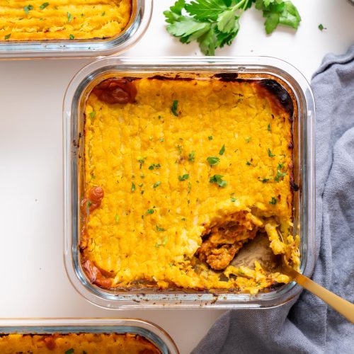 overhead baked cottage pie in a glass dish topped with parsley