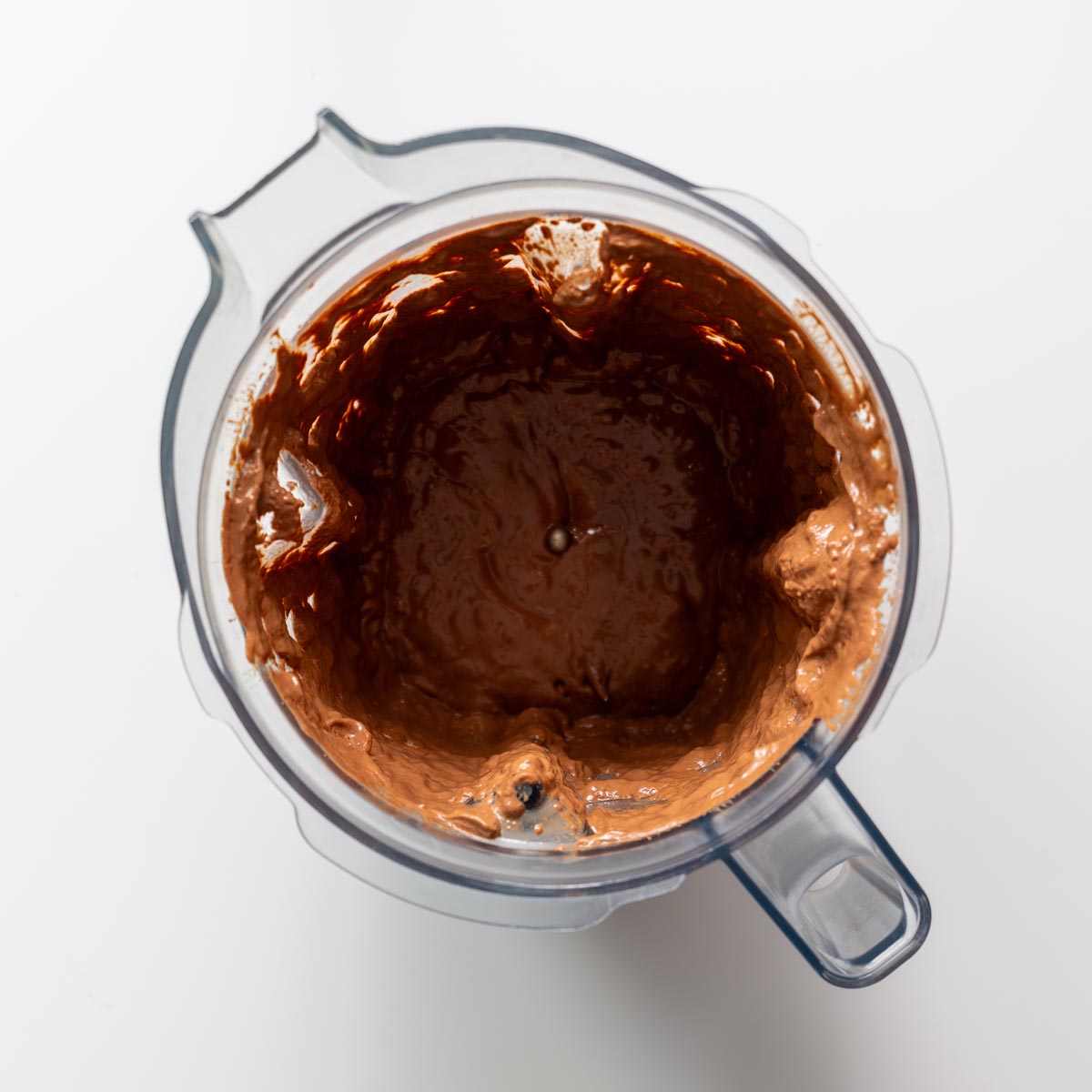 Blended tofu and chocolate mixture inside a blender jug