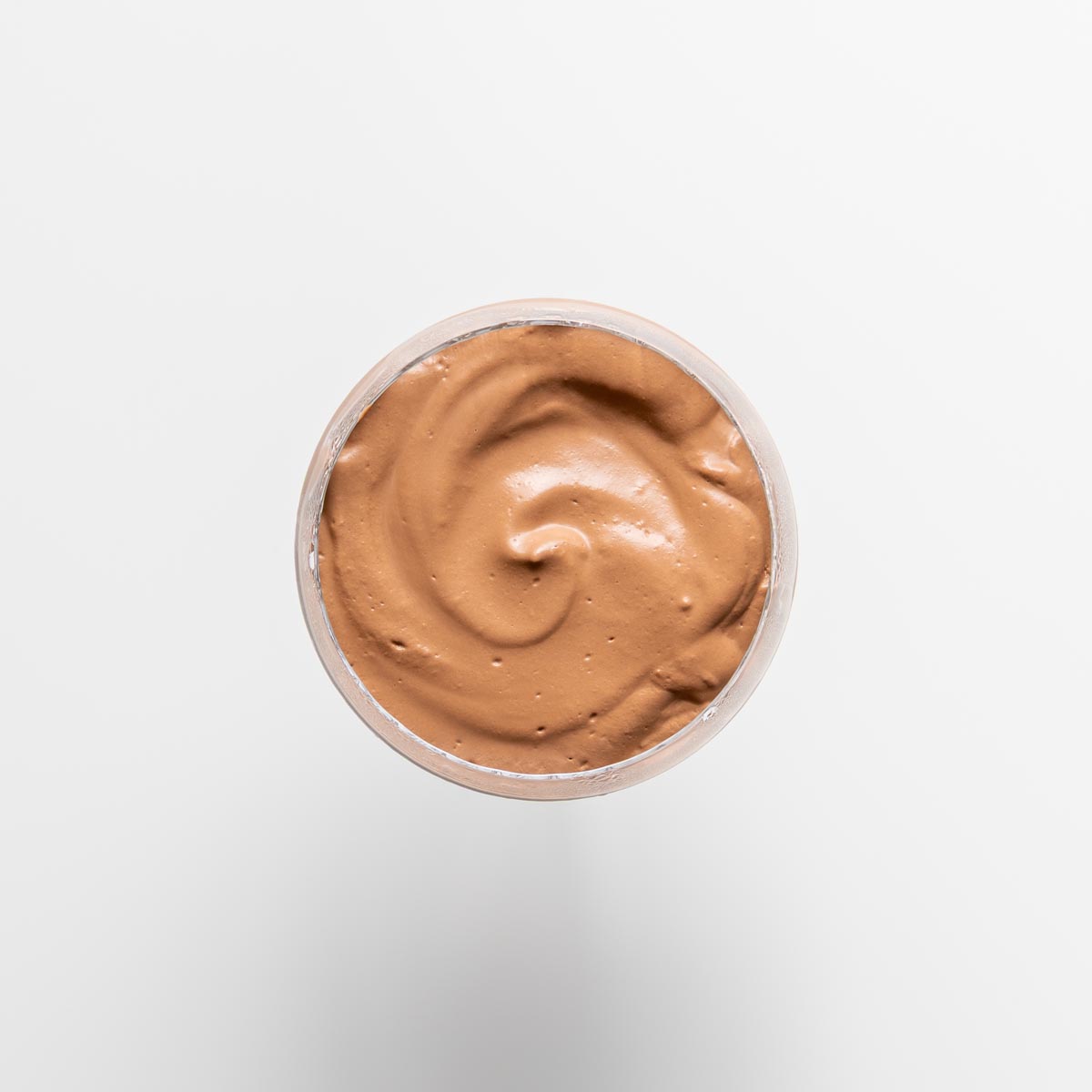 Top view of creamy chocolate mousse with a swirl finish