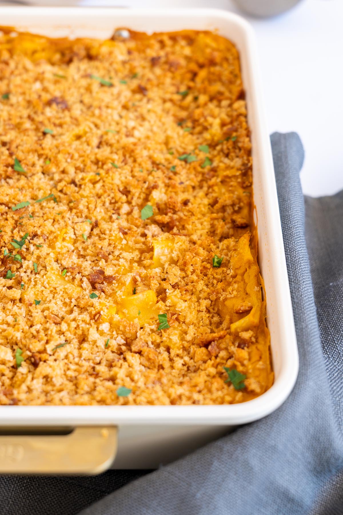 Close up of golden breadcrumb topping on baked vegan mac and cheese