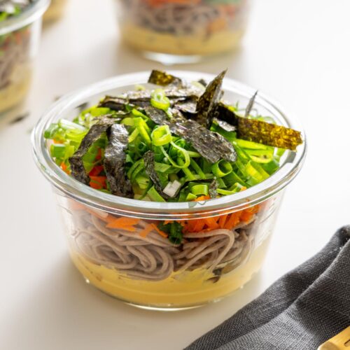 Miso noodle soup meal prep containers with nori and scallions on top.