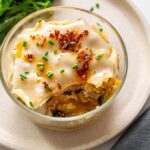 Soup dumpling lasagna in a glass bowl showing the savory filling inside.