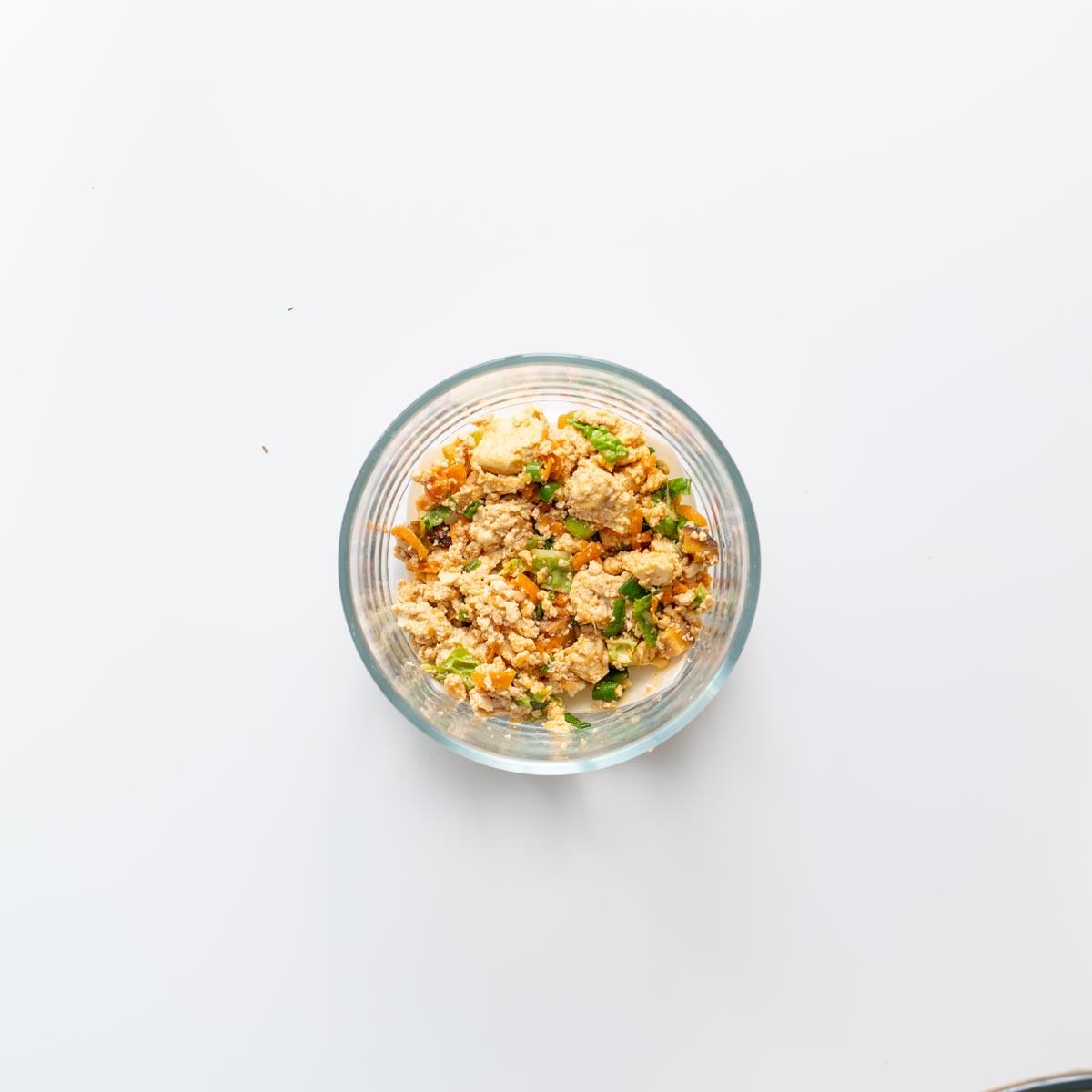 Step by step view of layering soup dumpling lasagna in a glass bowl.