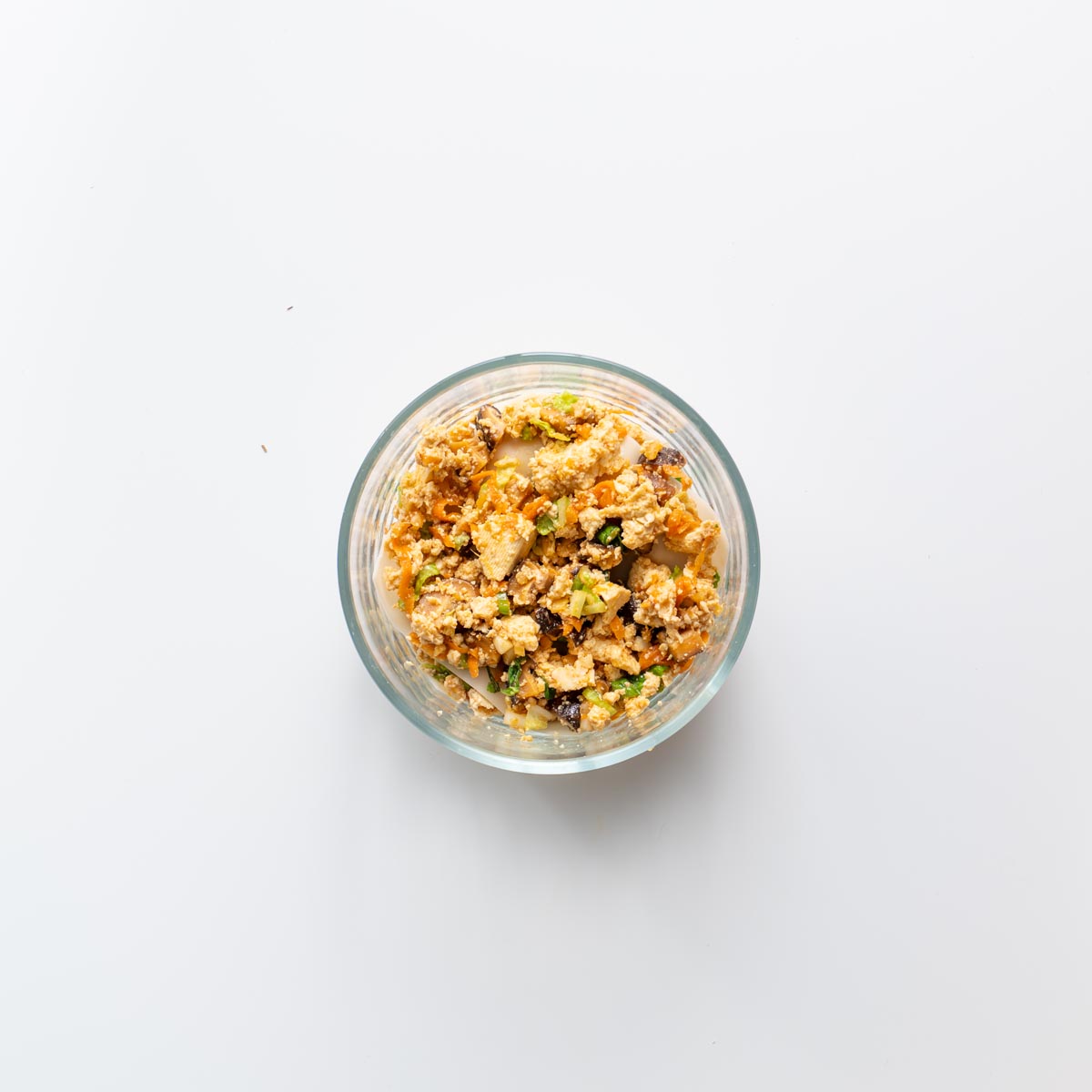 Step by step view of layering soup dumpling lasagna in a glass bowl.