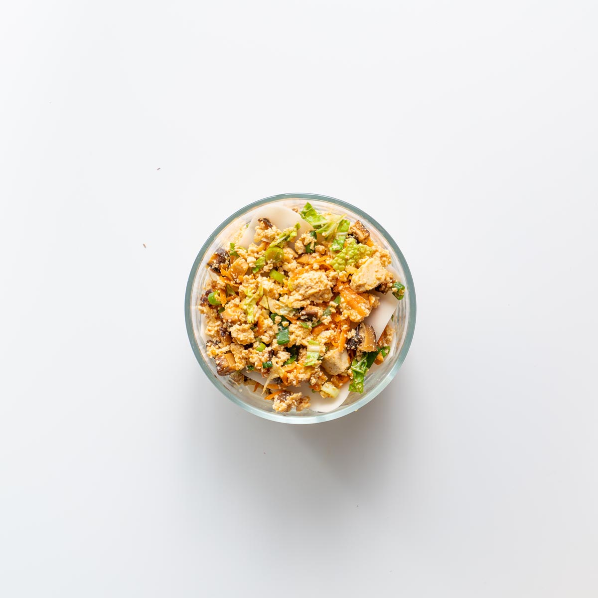 Step by step view of layering soup dumpling lasagna in a glass bowl.