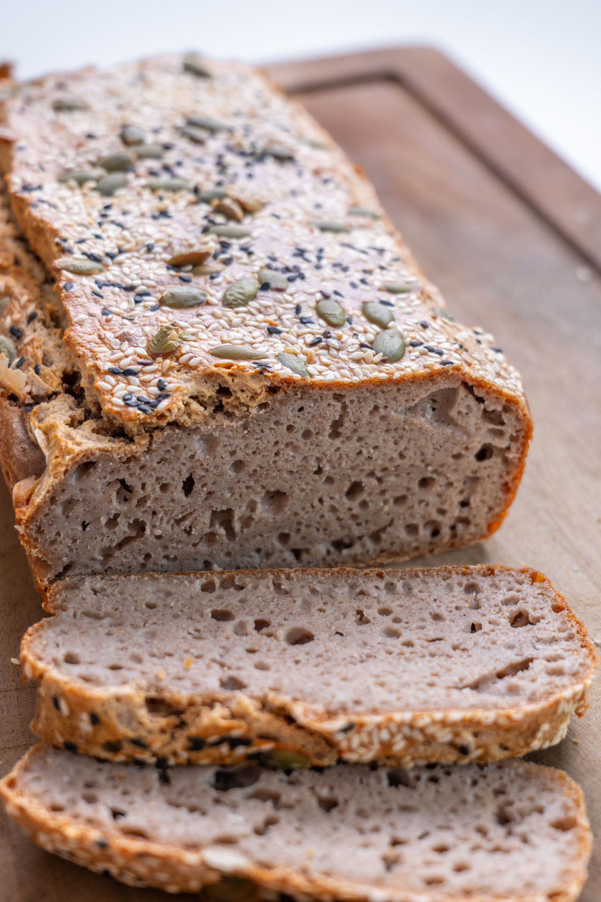Freshly sliced buckwheat bread on a wooden chopping board