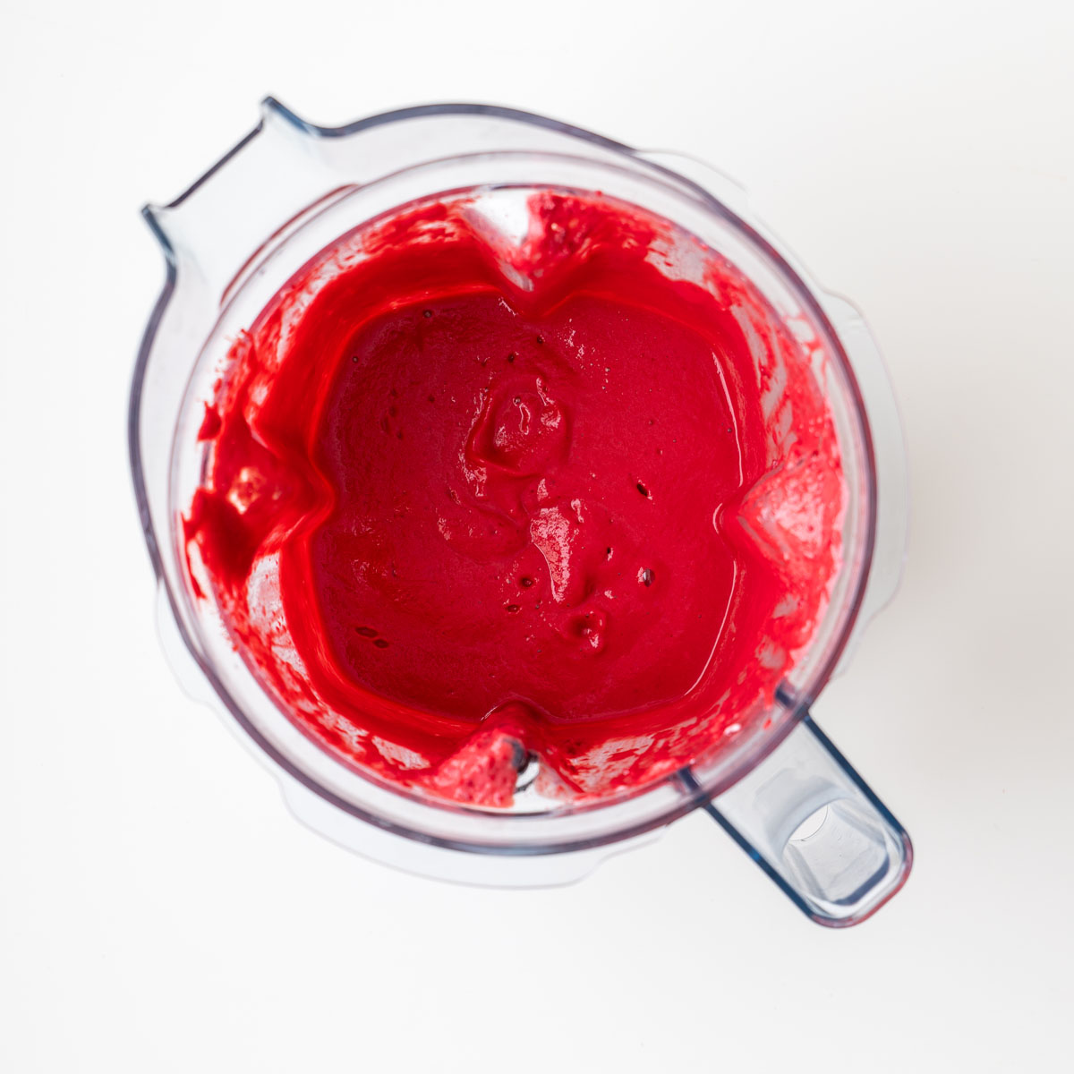 Vibrant pink beetroot sauce made with silken tofu, chickpeas, and lemon juice blended smooth in a blender