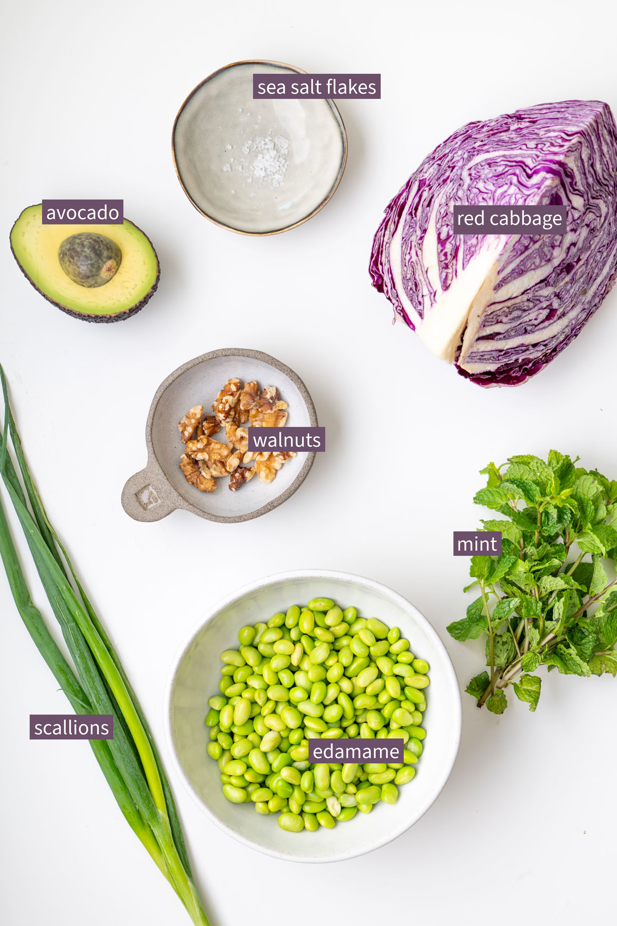 Turmeric quinoa and edamame salad with almond satay dressing served in a bowl with fresh mint and diced avocado