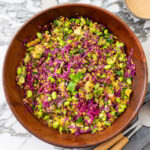 A serving of high-protein turmeric quinoa and edamame salad with red cabbage and almond satay dressing