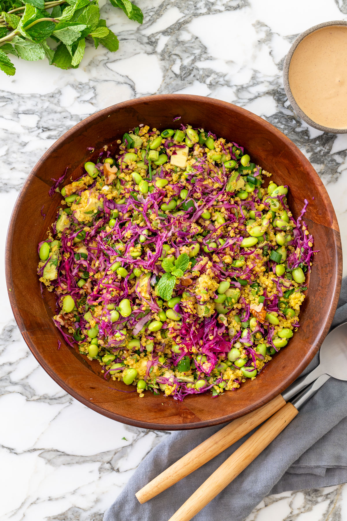 A serving of high-protein turmeric quinoa and edamame salad with red cabbage and almond satay dressing