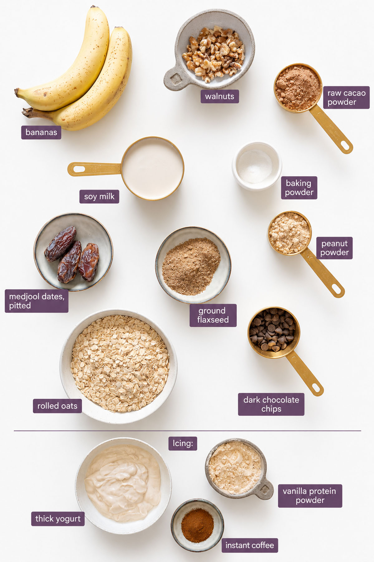 Vibrant ingredients for Brownie Baked Oats on a white surface, including rolled oats, bananas, Medjool dates, walnuts, soy milk, raw cacao powder, peanut powder, ground flaxseed, baking powder, dark chocolate chips, thick yogurt, vanilla protein powder, and instant coffee.