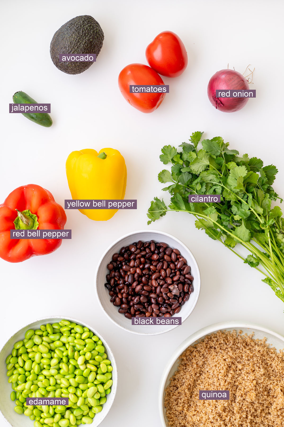 Vibrant ingredients for Cowboy Caviar-inspired salad on a white surface.
