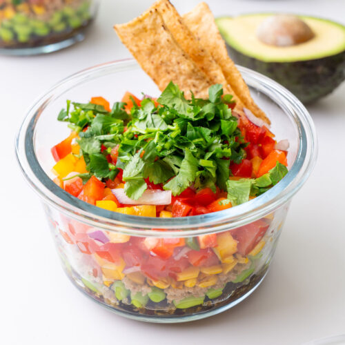 Close-up of Cowboy Caviar-inspired meal prep salad with cilantro, tortilla chips, and avocado.