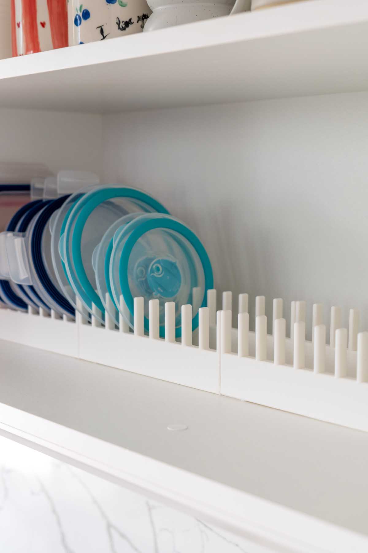 Close-up of a 3D printed lid rack keeping meal prep container lids standing on edge in size order