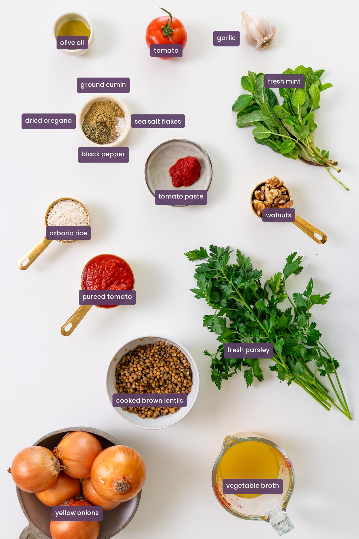 vibrant ingredients for Mediterranean stuffed onions labelled on a white surface.