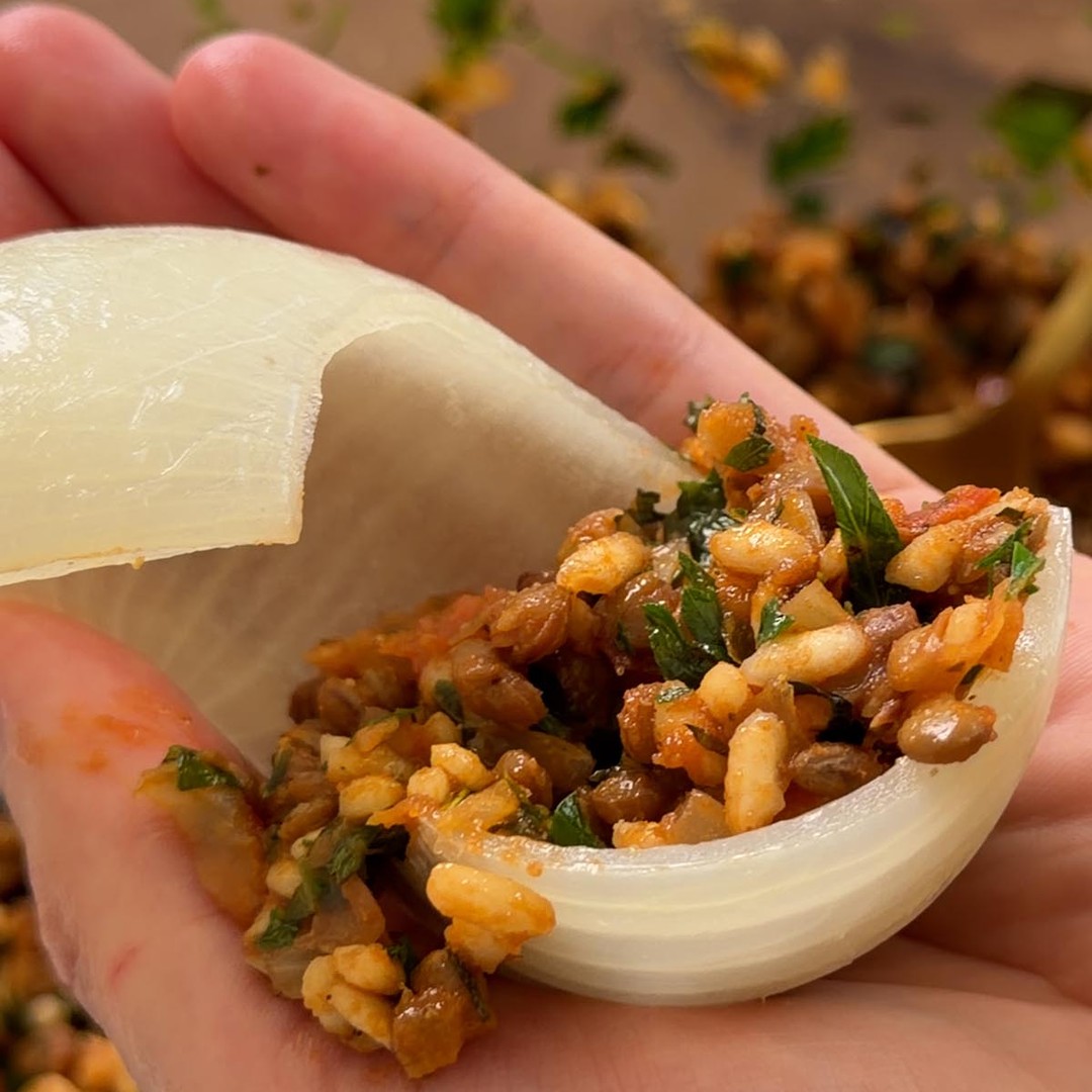 a softened onion layer filled with the lentil, rice and walnut mixture.