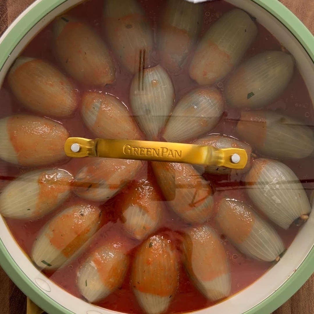the stuffed onions coated in tomato sauce, ready to go in the oven.