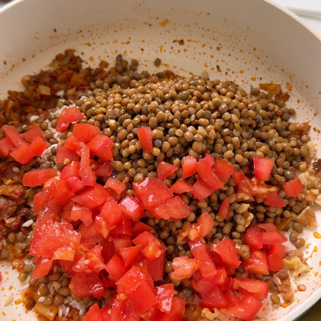 cooked brown lentils and diced tomato added to the pan with arborio rice and walnuts.
