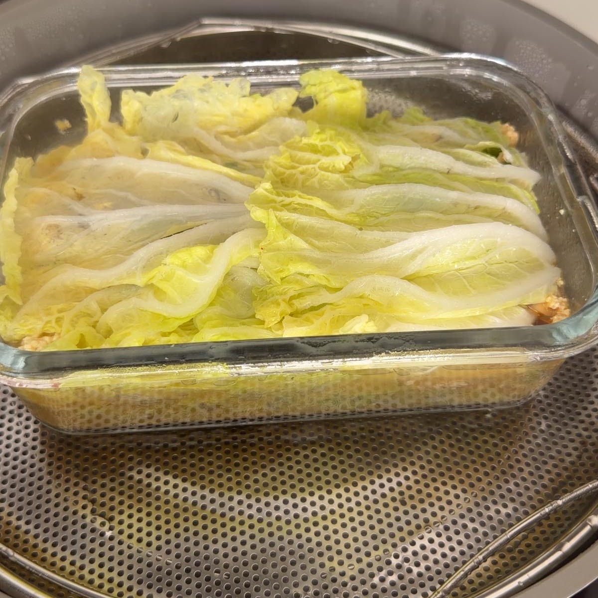 steamed cabbage soup dumpling lasagna in a steamer basket.