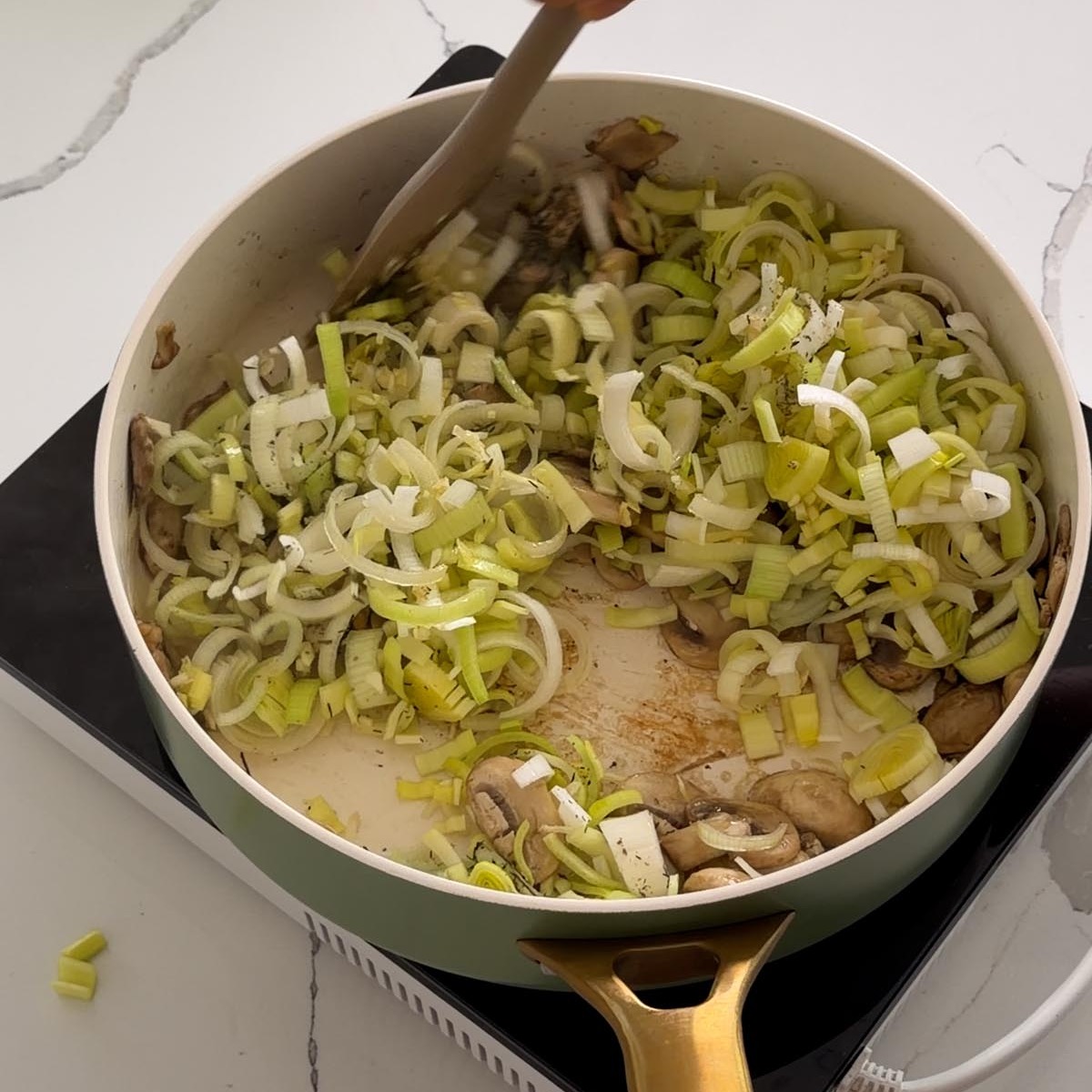 sliced leek, garlic and dried thyme added to the mushrooms in the pan.